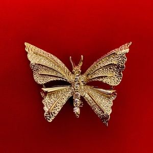 Vintage Gerry’s goldtone brooch with rhinestones. In excellent condition.